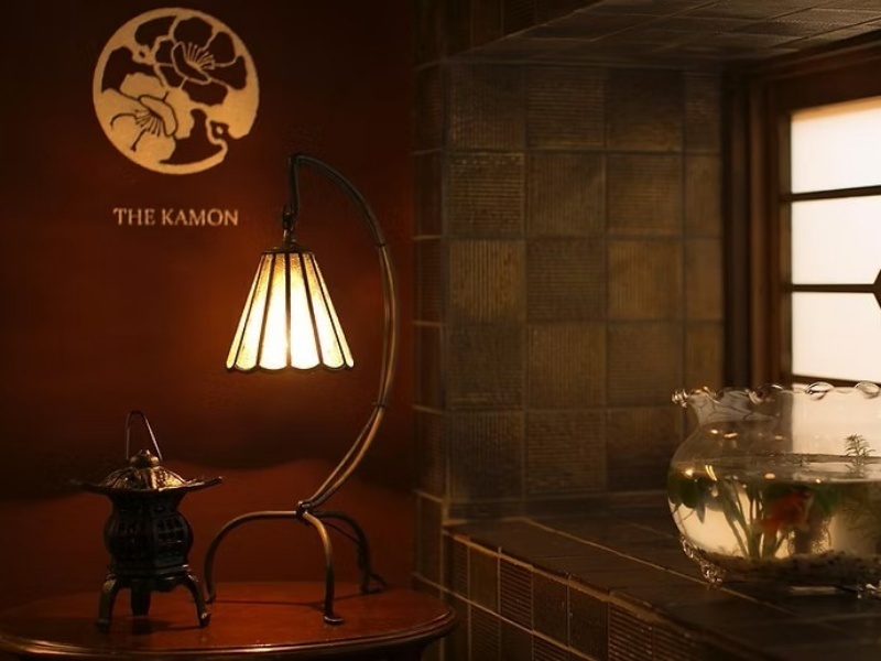 アンティークランプが灯る、趣のある空間。THE KAMONの看板が静かに浮かび上がる、非日常のひとときへの入口です。